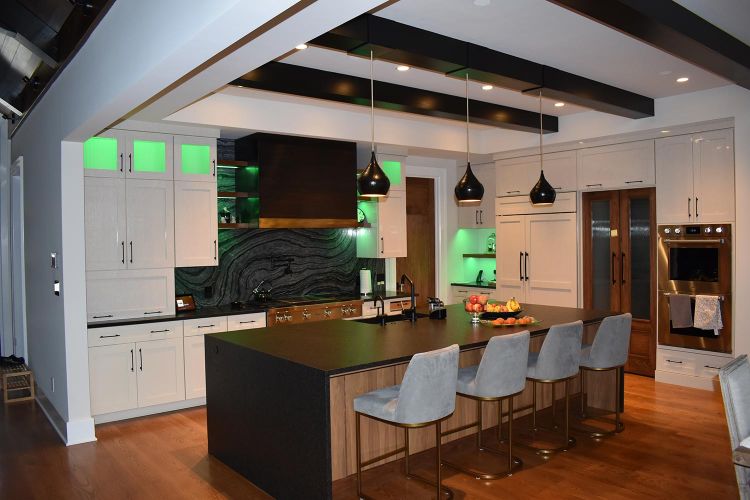 Modern kitchen featuring green under-cabinet lighting