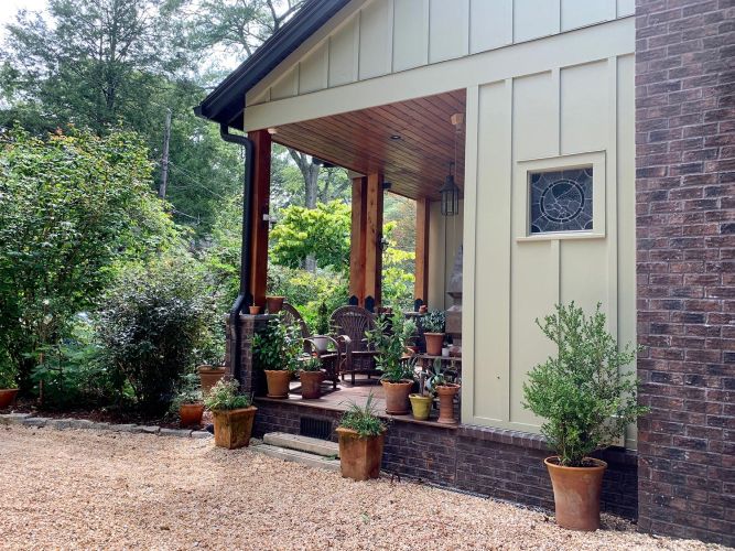 Close-up of same porch with wood ceiling and various plant arrangements