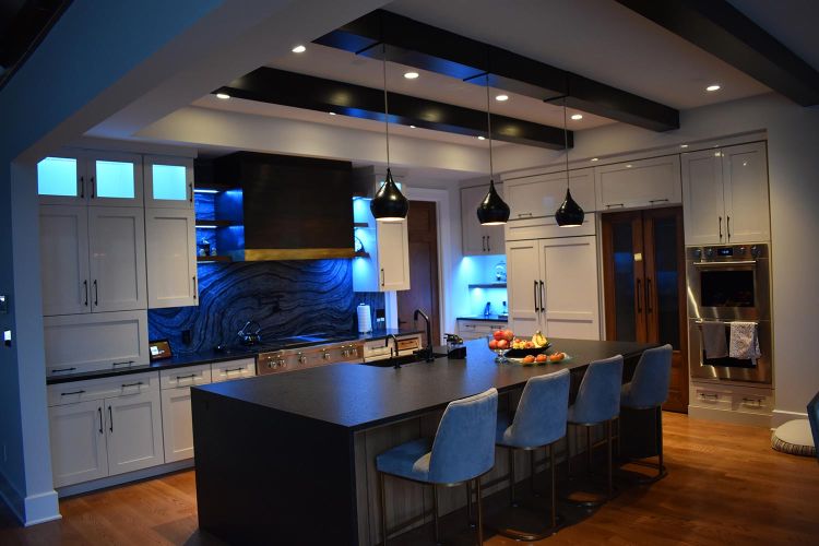 Kitchen with blue LED lighting and dark wood ceiling beams