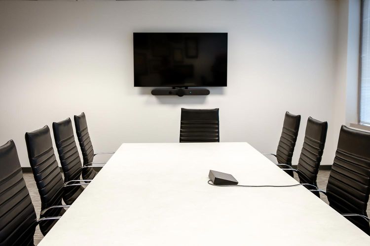 Boardroom with modern seating, TV, and conferencing soundbar system