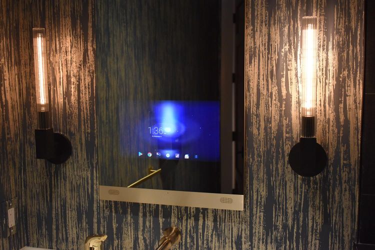 Smart mirror with digital display flanked by modern tube lights