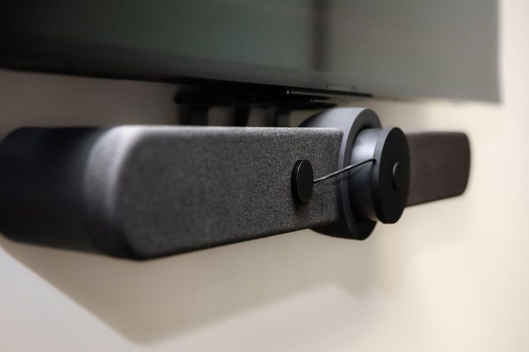 Side angle of modern video conferencing soundbar mounted to a wall