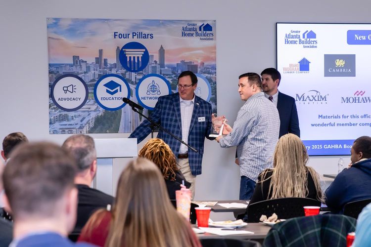 Man receiving an award from Greater Atlanta Home Builders Association during presentation