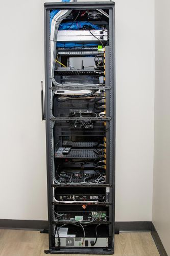 Full-height AV rack with structured cabling in a network equipment closet