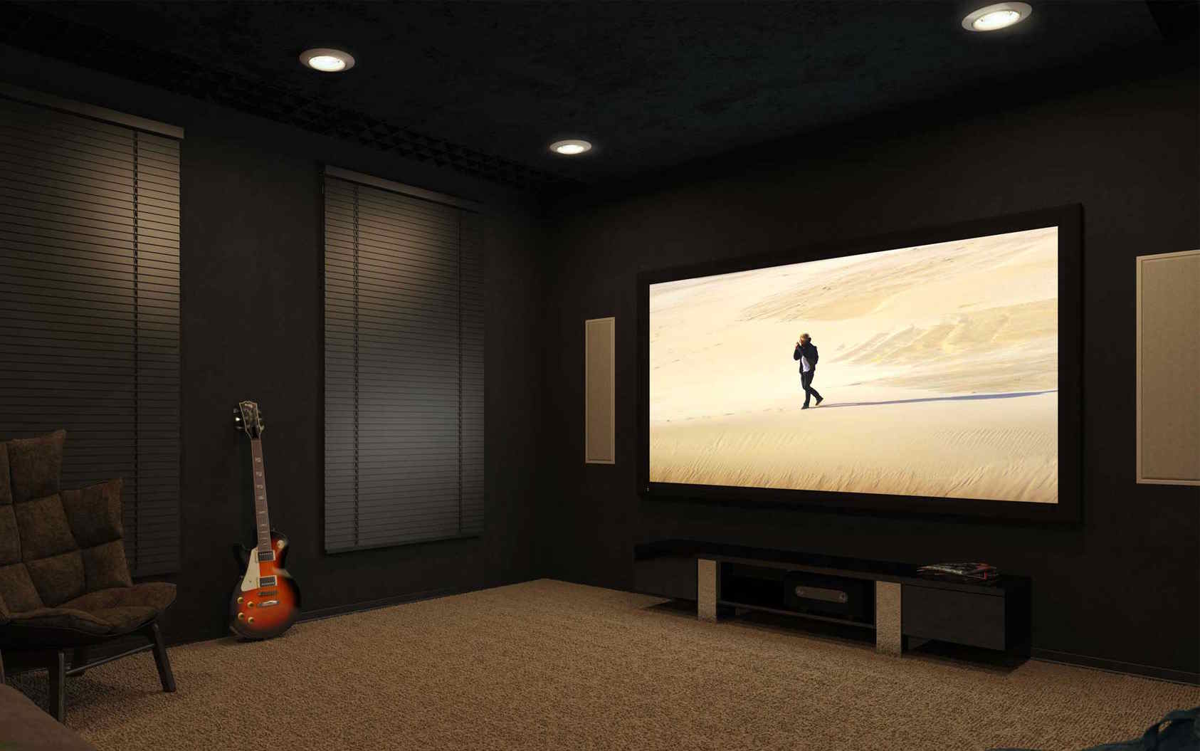 Modern home theater with dark walls, a large screen, and a guitar leaning nearby.